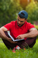 Young man wearing casual cloth reading book