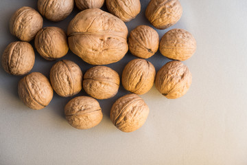 many walnut whole in shell on gray background