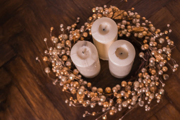 Christmas wreath and white candles.Christmas card with new year ornaments, decoration on wooden texture background. Selective focus. Happy New year composition.Christmas home decorations. Copy space. 