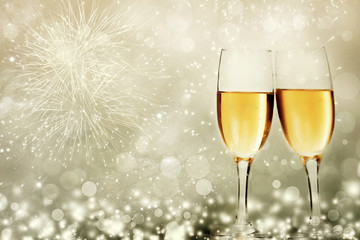 Glasses with champagne against fireworks