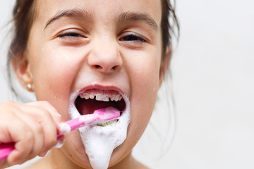 Little child with dental toothbrush brushing teeth.isolated on a white background