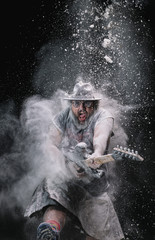 man with the guitar between chalk dust and smoke