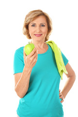 Sporty elderly woman with apple, isolated on white
