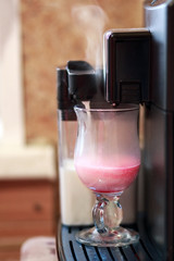 Cooking naturally delicious coffee with syrup in automatic coffee machine in the morning