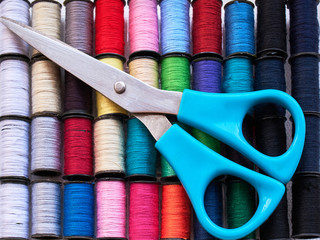 Spools of colorful silk thread and scissors