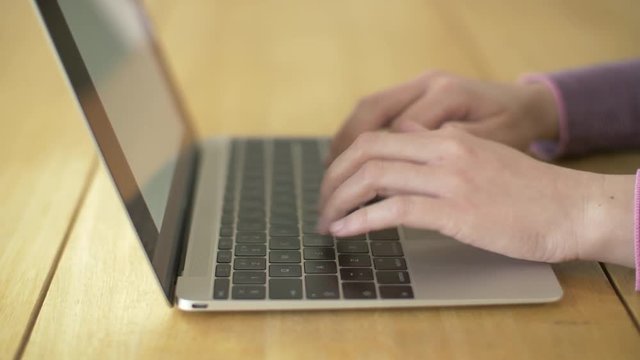 Closeup Footage Of Woman Using Laptop At Wooden Table