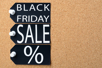 Obraz premium Black Friday sale tags are pinned to the cork board