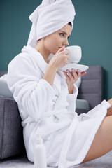 Beautiful woman enjoying morning coffee in bed