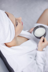 Beautiful woman enjoying morning coffee in bed