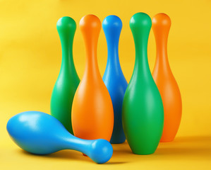 Bright bowling pins on color background