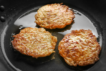 Frying pan with Hanukkah potato pancakes, closeup