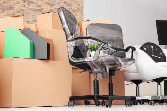 Carton boxes with stuff on floor in room. Office move concept