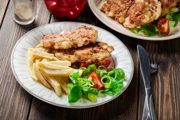 Chicken medallions with red peppers served with chips