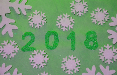 2018 with christmas decoration. concept of the new year and christmas. gold figures 2018 on the background of snowflakes on kraft paper.