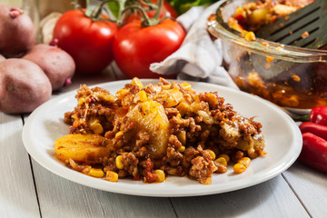 Portion of mexican potato casserole with minced meat