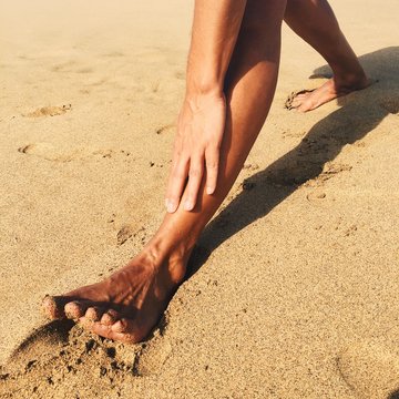 man stretching on the beach