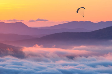 Paraglider over the sunset in a Crimea mountains