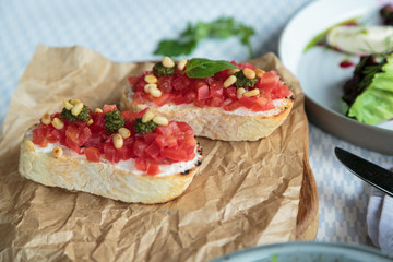 homemade bruschetta with pesto sauce, feta cheese, tomatoes and basil