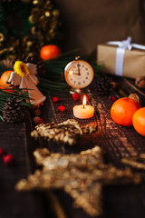 Christmas background with decorations and candles, candle on fire with woman hand