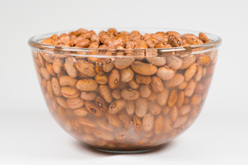 Dried orange coloured beans absorb water