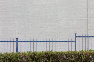 White wall behind blue grating (Pesaro, Italy)
