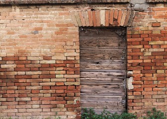 Wooden door of an old ruined building (Pesaro, Italy)
