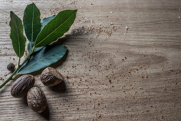 Nutmeg and bay leaf on wooden table