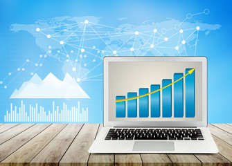 laptop on wood table office desktop, business chart and diagram with abstract background, computer...