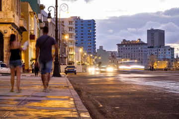 Street scene in Havana on the Malecon seaside avenue at sunset