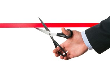 Businessman Cutting Red Ribbon