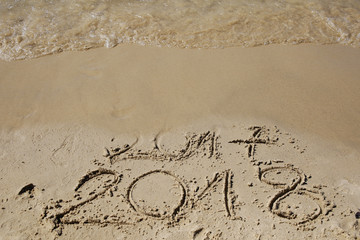 Sandy beach with current year written
