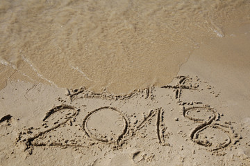 Sandy beach with current year written