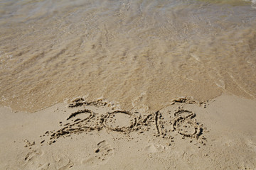 Sandy beach with current year written