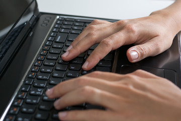 Human hands typing on the computer