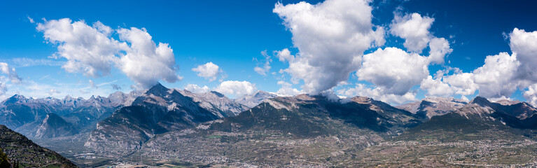 Alpine mountains with shadows of clouds, large panorama