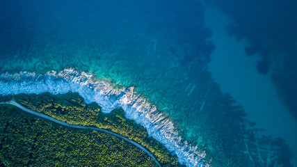 Coastline view from the drone, green forest and rocky coast
