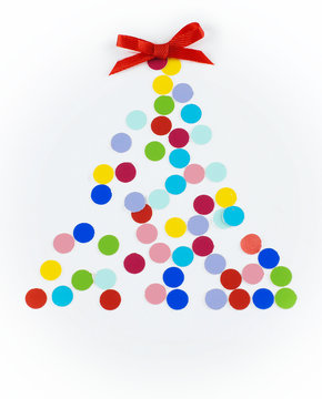 Colorful dots arranged into a Christmas shape on a light background with a red bow on top. Fun, cheerful image.