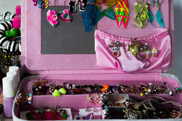  pink tealight jewelry box with colorful earrings, brooches and other trinkets