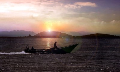 Small fishing boat at sunrise