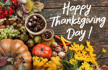 Thanksgiving day concept - traditional holiday food with pumpkins on old wooden 