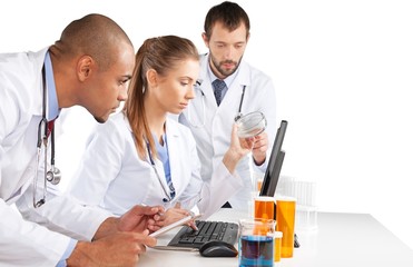 Portrait of Doctors Looking at Laptop and Writing on Clipboard