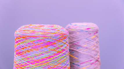 Reels or spools of multicolored sewing threads. Threads of all colors. Shallow depth of field. Close-up macro shot. colorful texture from threads for knitting