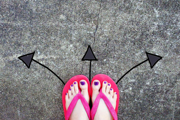 Violet Nail Pedicure. Woman’s Sandals Feet with Arrows Drawn Choices Direction on Cement Background Great for Any Use.