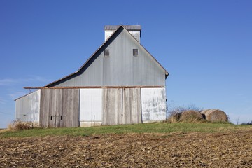 Old wooden and metal barn on a clear, blue sky, fall day