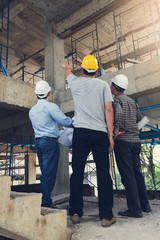 Construction concepts, Engineer and Architect working at Construction Site with blueprint, Vintage...