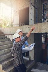 Fototapeta premium Construction concepts, Engineer and Architect working at Construction Site with blueprint, Vintage Effect