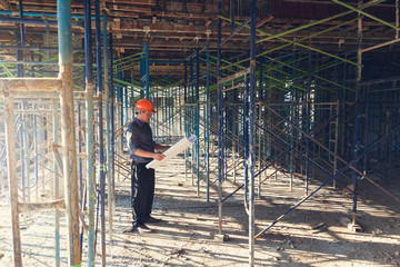 Construction concepts, Engineer and Architect working at Construction Site with blueprint, Vintage Effect