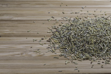 pile of dried rosemary on a bamboo cutting board background