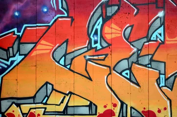 Ein Fragment eines detaillierten Graffitis einer Zeichnung, die mit Aerosolfarben auf einer Wand aus Betonfliesen erstellt wurde. Hintergrundbild der Straßenkunst in warmen roten Farbtönen © mehaniq41
