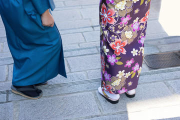 Women in traditional japanese kimonos walking at temple with sunset in Kyoto, Japan
